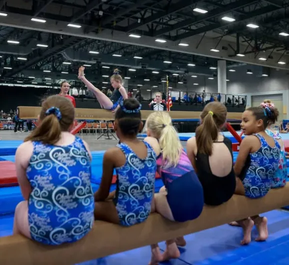 Teammates cheer from the sidelines